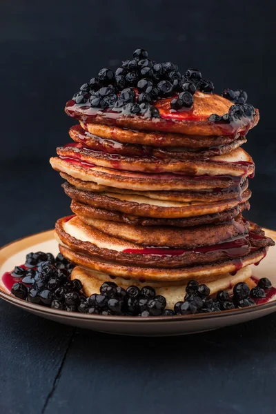 Pancakes with fresh berries and blueberry jam on the wooden table — Stock Photo, Image