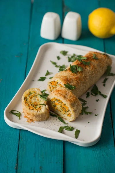 Fish roll with greens and carrot on the cyan table vertical — 스톡 사진