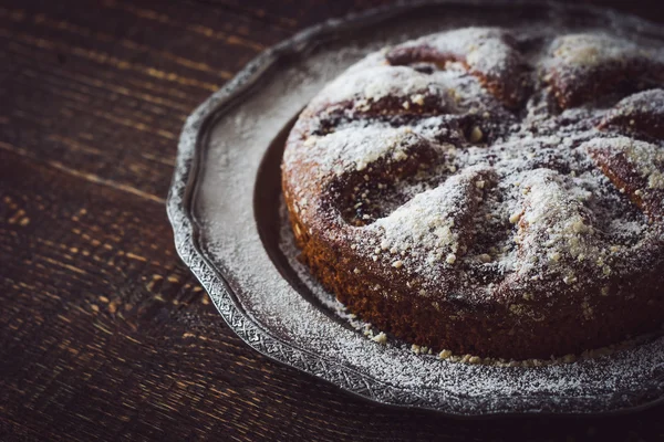 Torta con zucchero a velo sulla vecchia piastra metallica vintage — Foto Stock