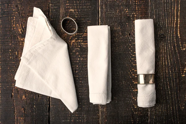 Set of the napkins with vintage rings on the wooden table — Stock Photo, Image