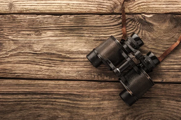 Binoculars on the wooden table Stock Photo
