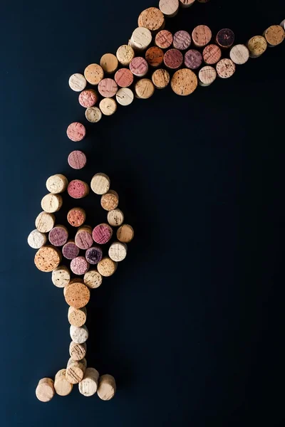 Filling a glass pf wine from the bottle made by corks vertical — Stock Photo, Image