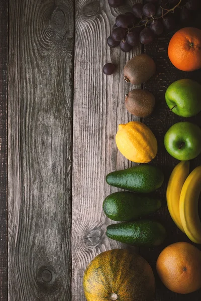 Assorted fruit at the right of the wooden table top view — Stock Photo, Image