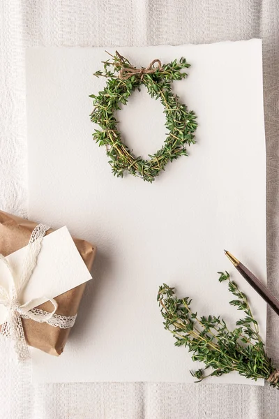 Christmas card with wreath of rosemary and present vertical — Stock Photo, Image