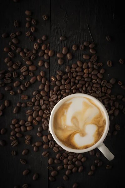 Cappuccino with coffee beans vertical — Stock Photo, Image