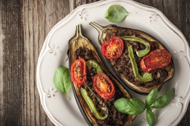Eggplant with minced meat and vegetable on the wooden table top view