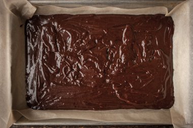 Dough for chocolate brownie on the baking tray