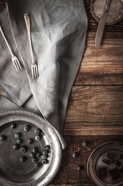 Vintage plates with blueberry and chocolate on the wooden table vertical