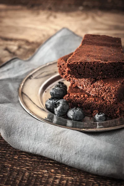 Chocolate brownie with blueberry on the wooden table vertical — Stock Fotó