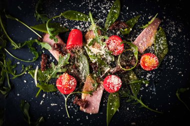 Jambon füme ve karanlık taş üstten görünüm üzerinde Roka Salatası