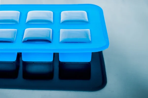 Ice cube tray with ice on the table — Stock Photo, Image