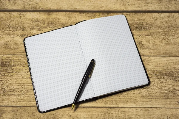 Empty notebook on a wooden table — Stock Photo, Image