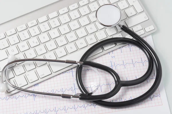 Estetoscópio, ecg e teclado na mesa do médico — Fotografia de Stock