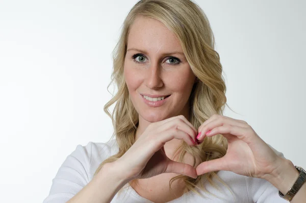 Female forming heart with her hands — Stock Photo, Image