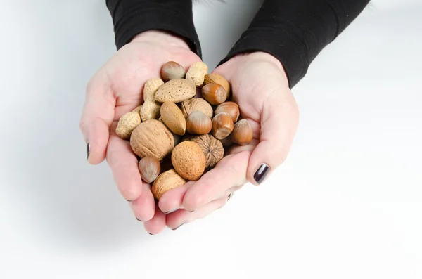 Vrouw met noten in haar hand — Stockfoto