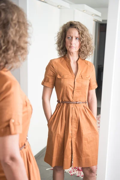Woman is looking at herself in Mirror — Stock Photo, Image