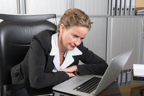 Female chef in the office with too much work — Stock Photo, Image