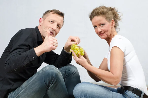 Casal comendo uvas — Fotografia de Stock