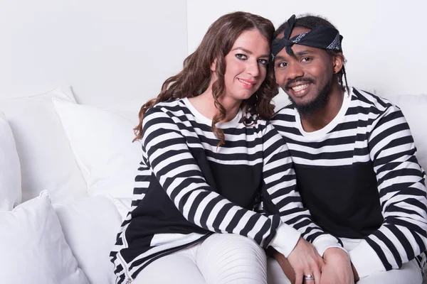 Loving couple sitting on couch — Stock Photo, Image