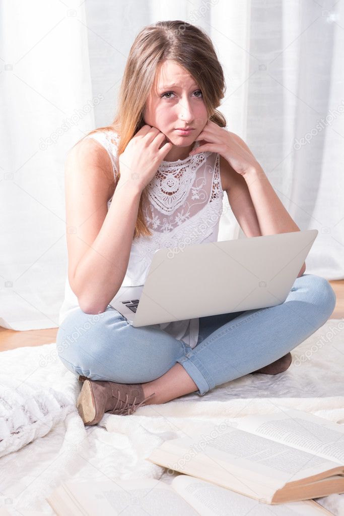 young student reading on blanket