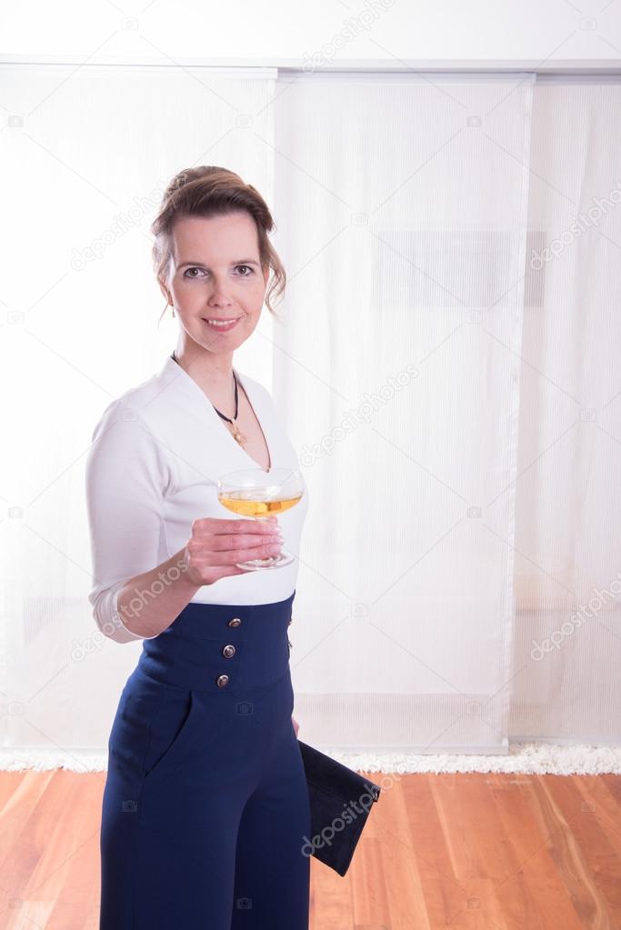 attractive woman in evening outfit with glass of champagne