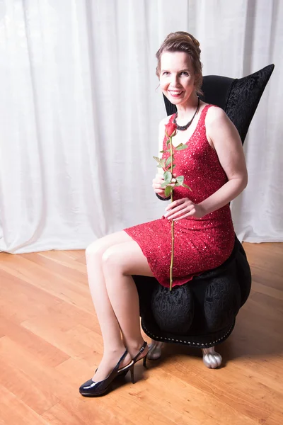 Attractive woman in red dress with rose — Stock Photo, Image