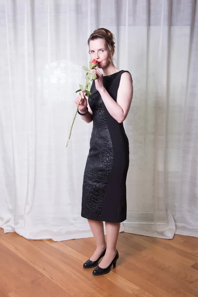 Portrait attractive woman with rose in her hand — Stock Photo, Image