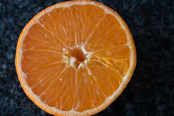 freschly cut orange slice on black background