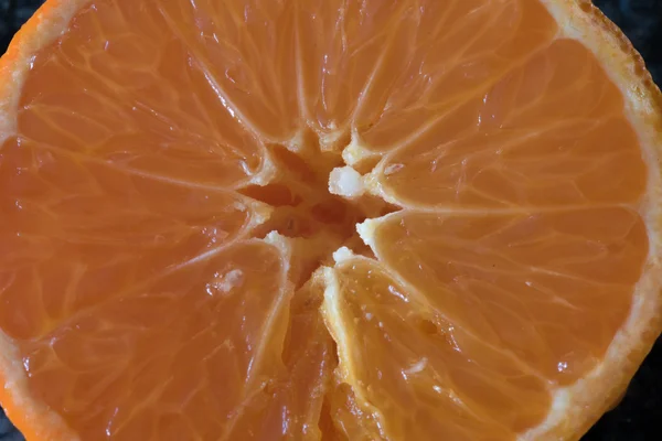 freschly cut orange slice on black background