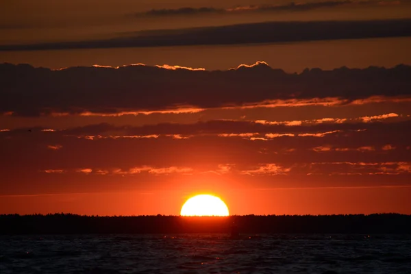 Bright big sun on the sky with clouds