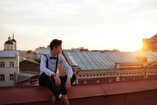 Happy hipster girl on the edge of the roof