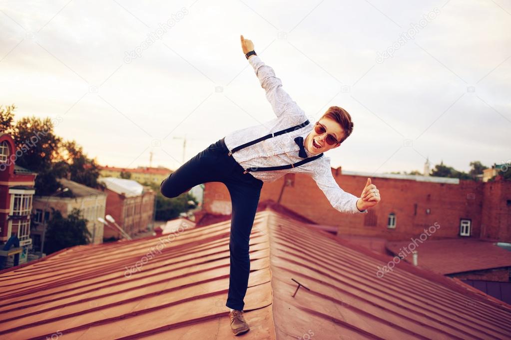 Young happy hipster girl jump on roof
