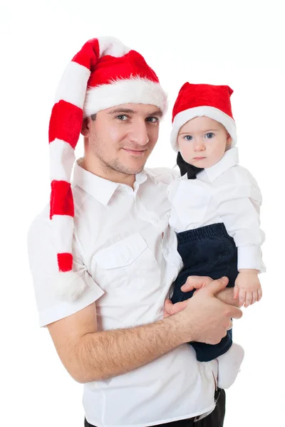 Glad söt familj far och son i santa hattar — Stockfoto