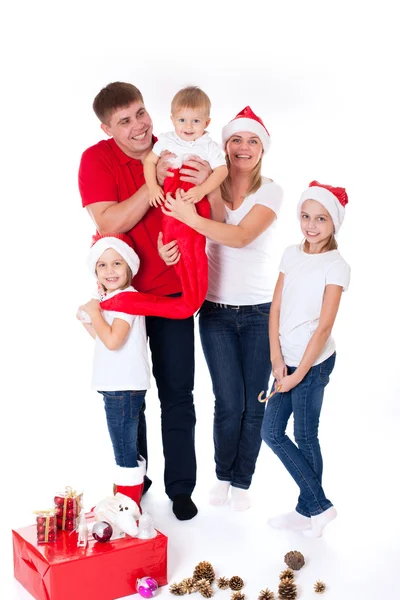 Happy cute family in santa's hats — Stock Photo, Image