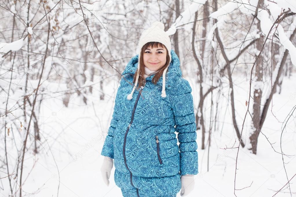 Pregnant woman in winter forest