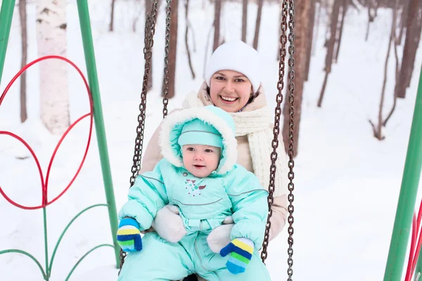 Happy family mother and baby in park in winter — Stock Photo, Image