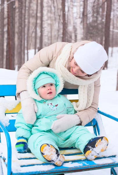 Happy family mother and baby in park in winter — Stock Photo, Image