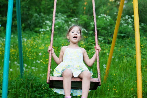 Little beautiful girl swinging in park — Stock Photo, Image