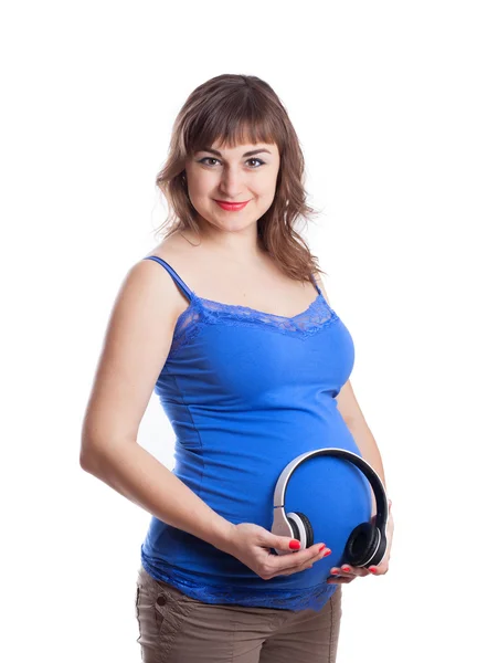 Mujer embarazada hermosa joven con auriculares cerca del vientre —  Fotos de Stock