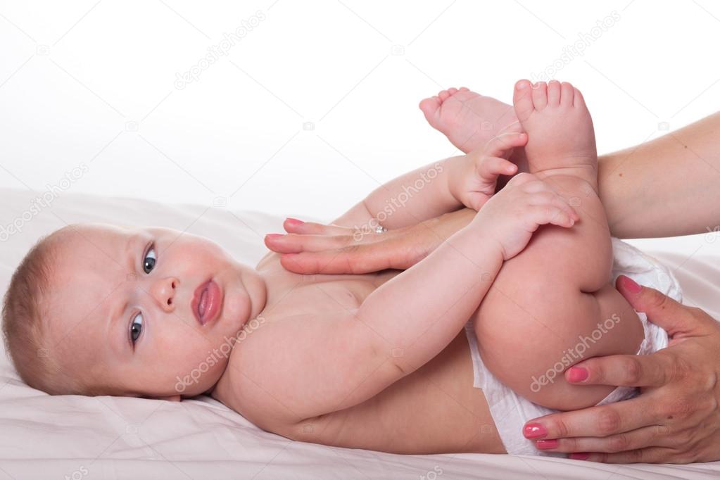 Hands massaging baby