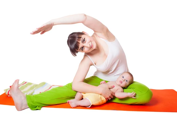 Young woman mother practicing yoga with baby — Stock Photo, Image