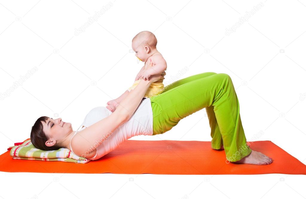 Young woman mother practicing yoga with baby