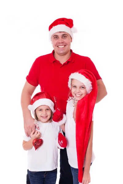 Pai feliz e duas filhas nos chapéus do Papai Noel rindo — Fotografia de Stock