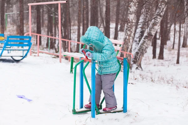Happy kid girl child outdoors in winter playing and training — Stock Photo, Image