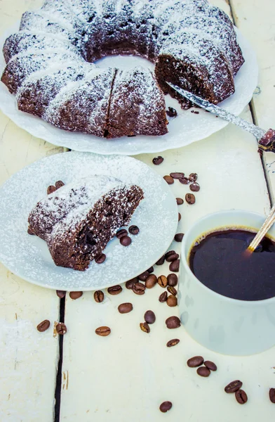 El abundante desayuno magdalena de chocolate con azúcar en polvo y café caliente — Foto de Stock