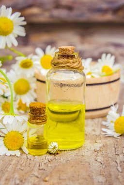 extract of chamomile in a small bottle milking cosmetics and treatment clipart