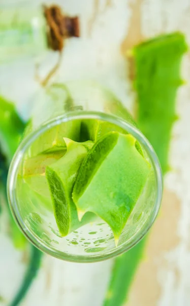 Extract of organic aloe vera gel on wooden background — Stock Photo, Image