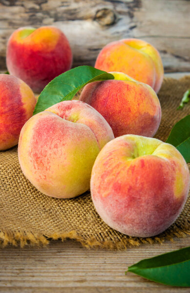 juicy ripe yellow peaches on the table.