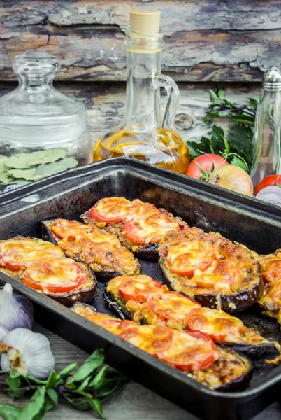 Eggplant baked in the oven with tomatoes and cheese. — Stock Photo, Image