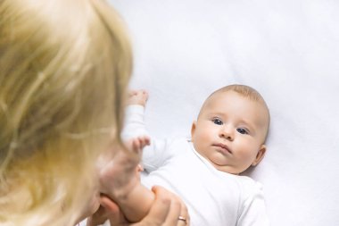 Işıklı arka planda bebeği olan anne. Seçici odaklanma. İnsanlar.